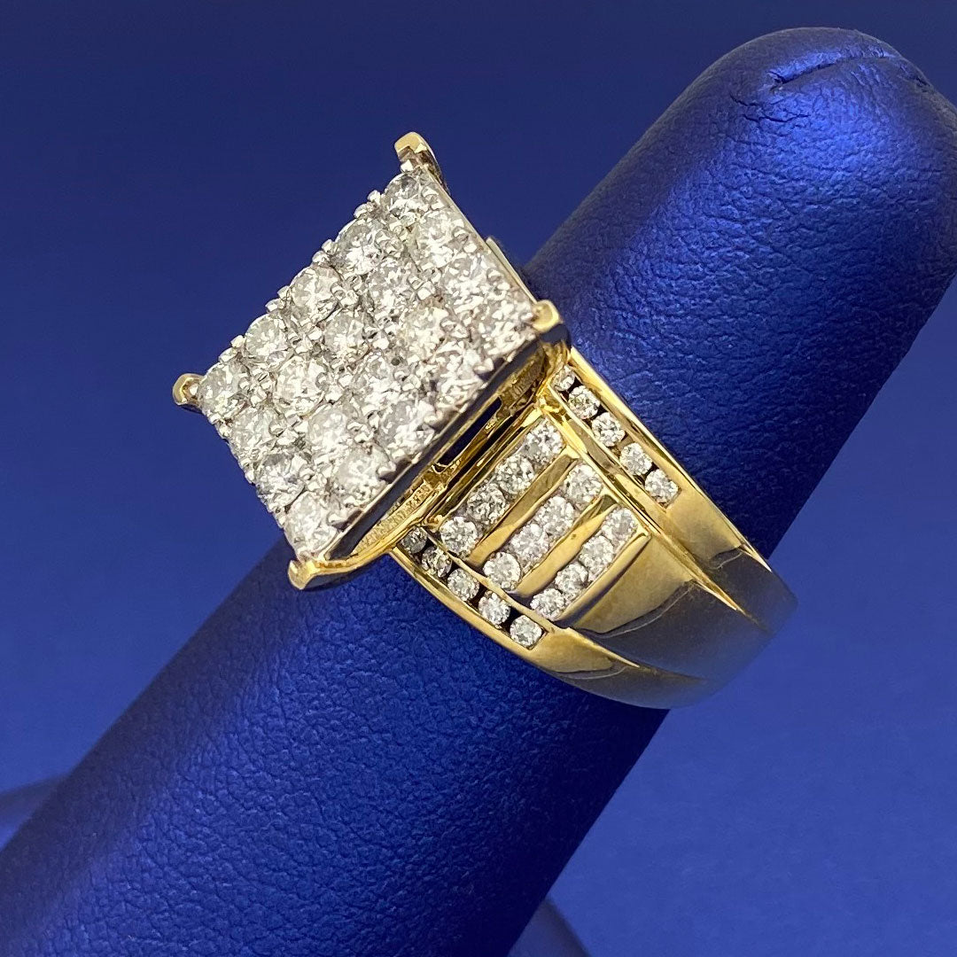 Gold ring with diamond square cluster on a blue finger display side